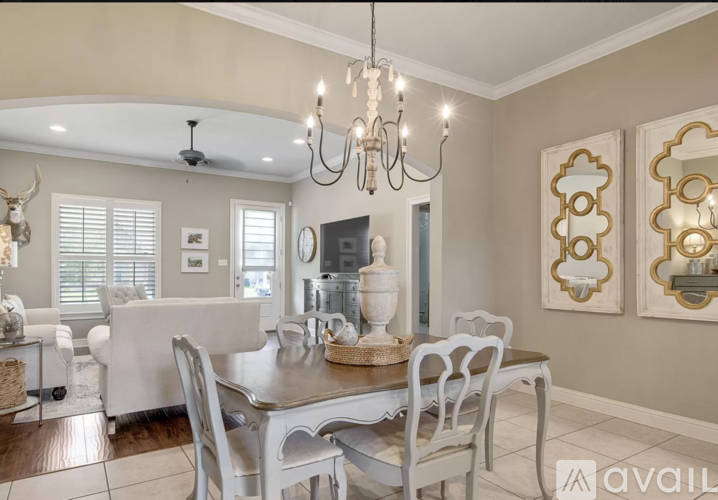 A dining room with a table set for six.