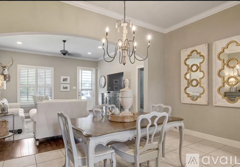 A dining room with a table set for six.