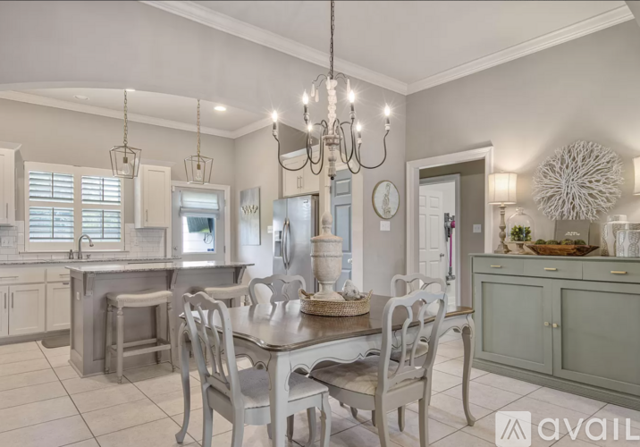A modern kitchen with a dining table and chairs.