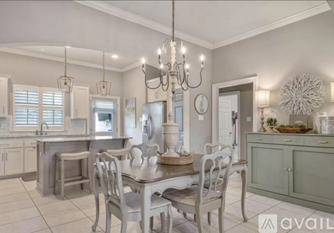 A modern kitchen with a dining table and chairs.