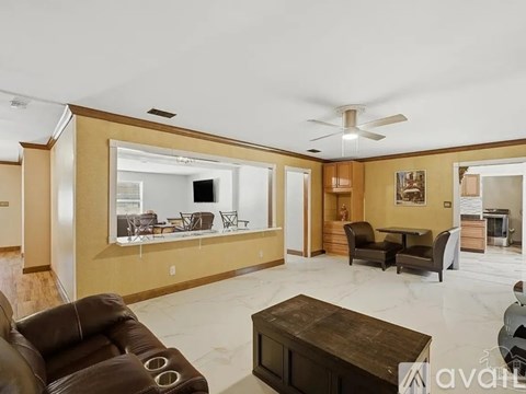 A living room with a brown leather couch and a wooden coffee table.