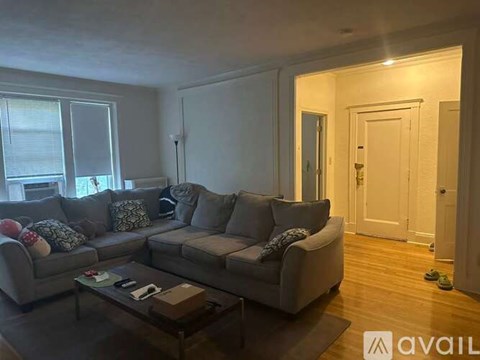 A living room with a grey couch and a coffee table.