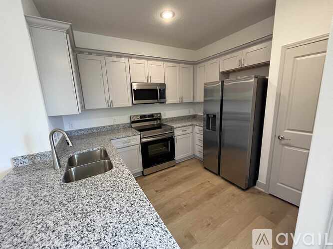 A kitchen with granite countertops and stainless steel appliances.