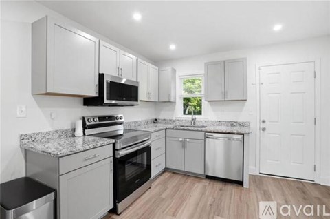 A kitchen with white cabinets and stainless steel appliances.