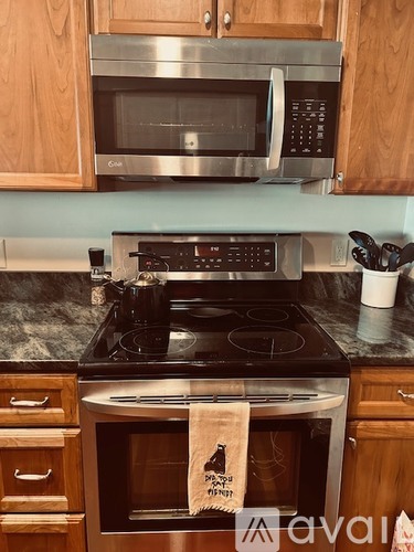 A kitchen with a stove top oven and microwave above it.