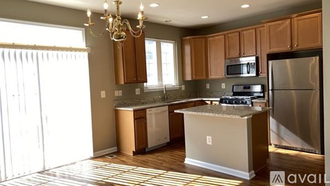 A kitchen with wooden cabinets and a granite countertop.