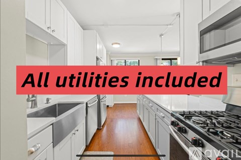 A kitchen with a red banner that reads "All utilities included".
