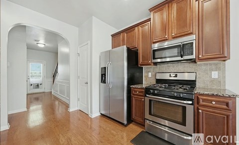 A kitchen with wooden cabinets and stainless steel appliances.