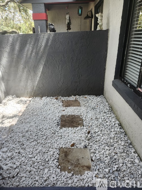 A gravel pathway leads to a building.