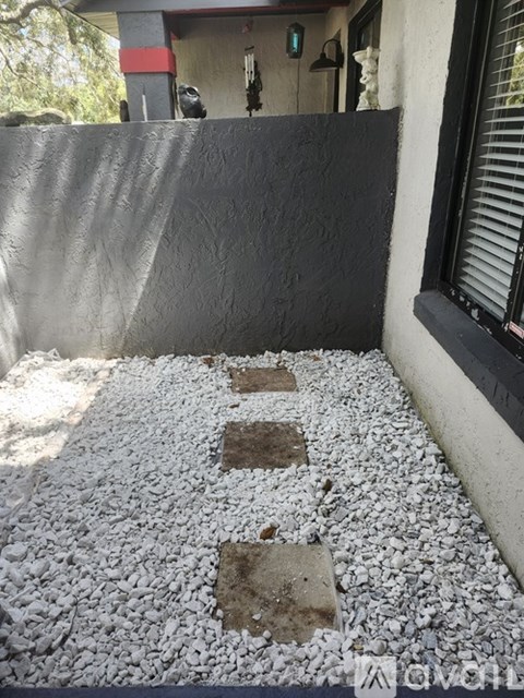 A gravel pathway leads to a building.