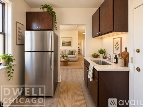 A kitchen with a refrigerator and a sink.