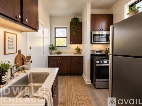 A kitchen with a refrigerator, sink, and oven.