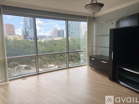 A living room with a large window overlooking a cityscape.