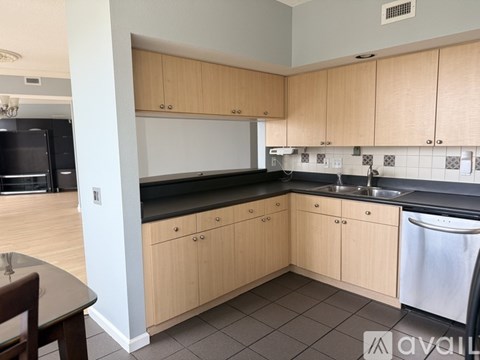 A kitchen with wooden cabinets and a black countertop.