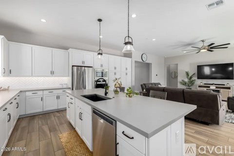 A modern kitchen with white cabinets and a central island.