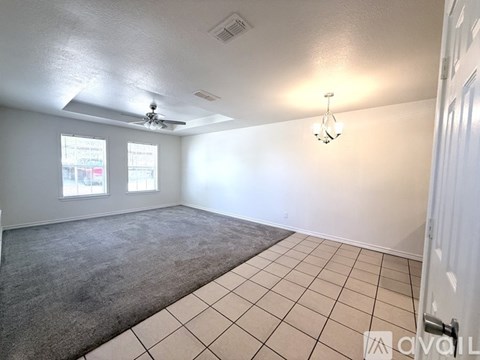 Empty room with tiled floor and ceiling fan.