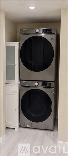 A washing machine is sitting in a laundry room.