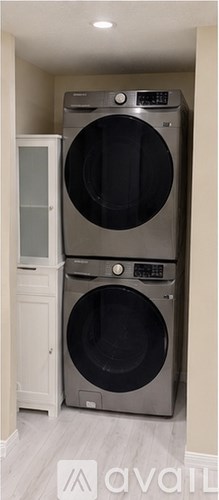 A washing machine is sitting in a laundry room.