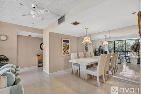 A living room with a dining table and chairs.
