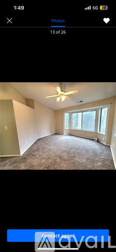 A room with a ceiling fan and a window.