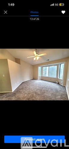 A room with a ceiling fan and a window.