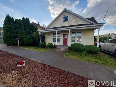 A house with a red door is for sale.