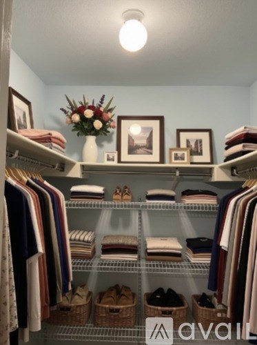 A closet with clothes and shoes on shelves.