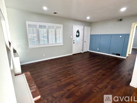 A room with wooden floors and a white door.