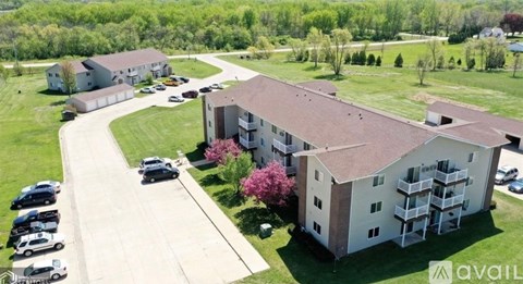 A large building with a parking lot in front of it.