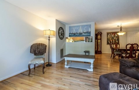 A living room with a white sofa and a wooden floor.