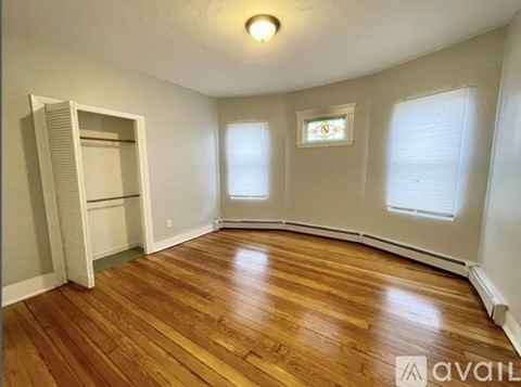 A room with wooden floors and a large open closet.
