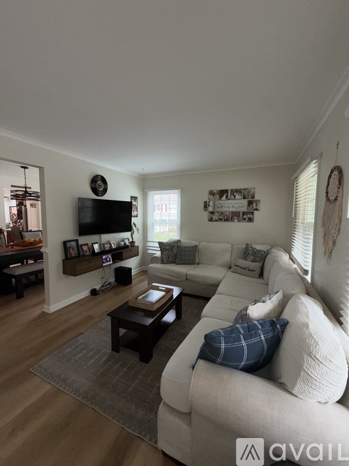 A living room with a white couch and a coffee table.