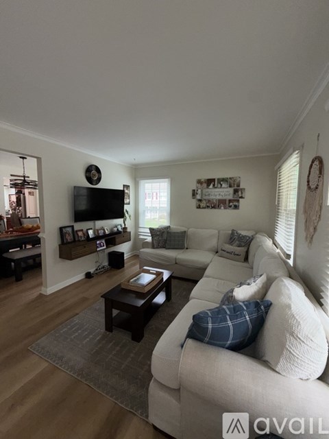 A living room with a white couch and a coffee table.