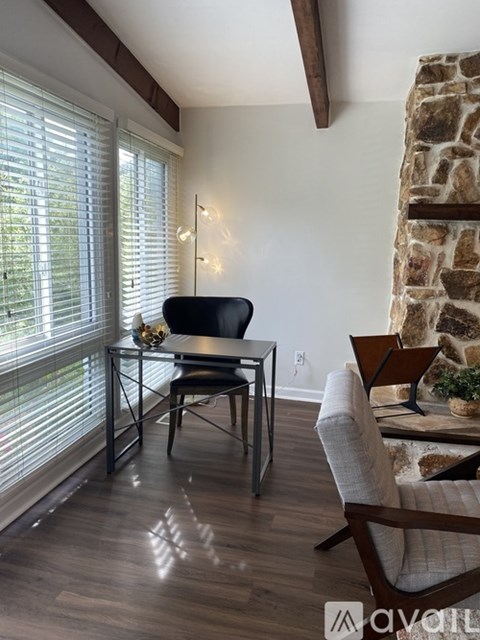 A dining room with a table and chairs.