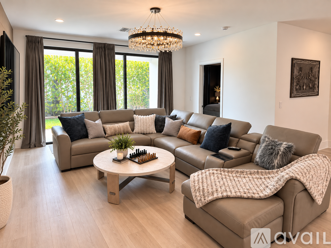 A living room with a large sectional sofa and a coffee table.