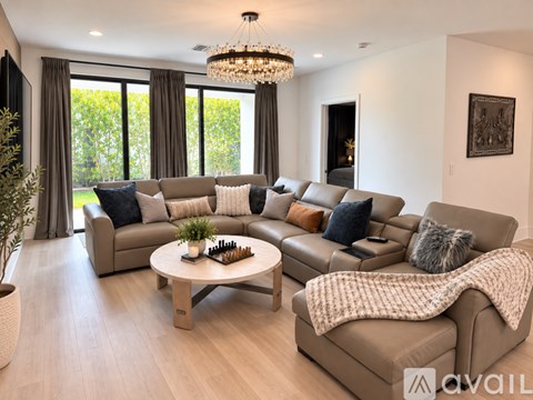 A living room with a large sectional sofa and a coffee table.