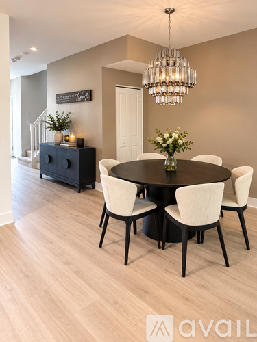 A modern dining room with a round table and chairs.