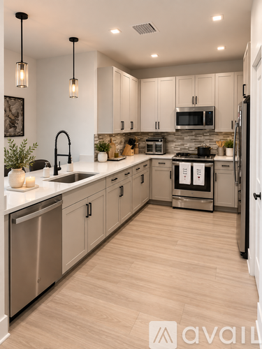 A modern kitchen with wooden floors and stainless steel appliances.