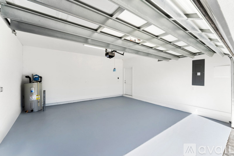 A spacious room with a white ceiling and a grey floor.