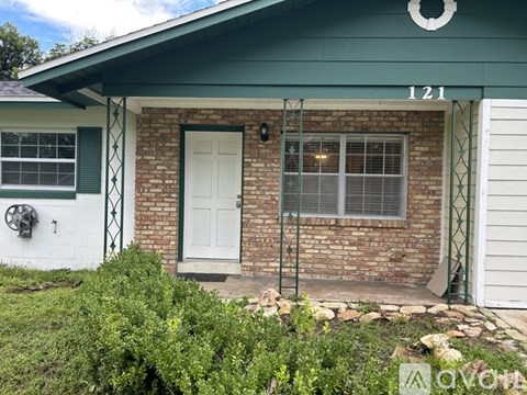 A house with the number 121 on the front.