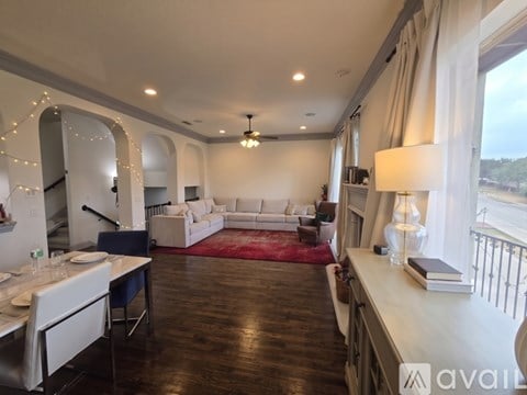 A well-lit, spacious living room with a dining table and a couch.