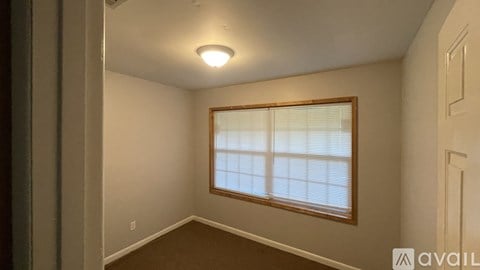A room with a window and a door.