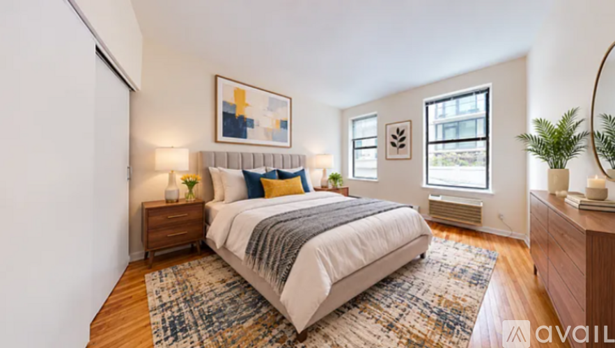 A bedroom with a large bed and a painting on the wall.