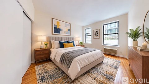 A bedroom with a large bed and a painting on the wall.