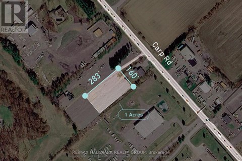 An aerial view of a property with a 1 acre plot and a road passing through it.