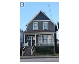 A two-story house with a grey front and white trim.