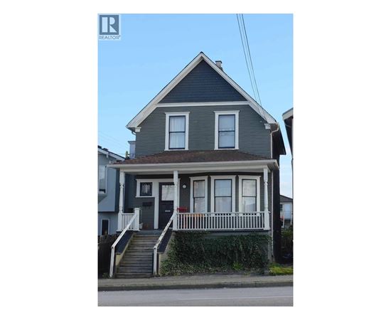 A two-story house with a grey front and white trim.