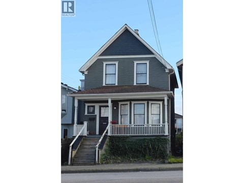 A two-story house with a grey front and white trim.
