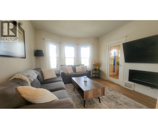 A living room with a grey couch and a coffee table.