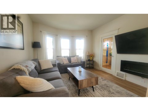 A living room with a grey couch and a coffee table.